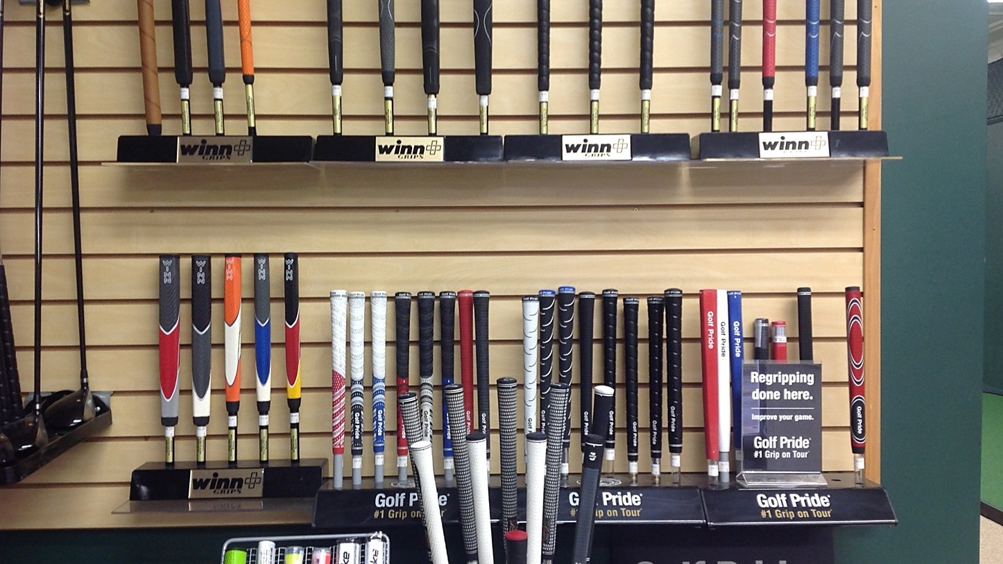 A wall of Golf Pride, Winn, and SuperStroke grips in the Oakmont Golf Center repair shop